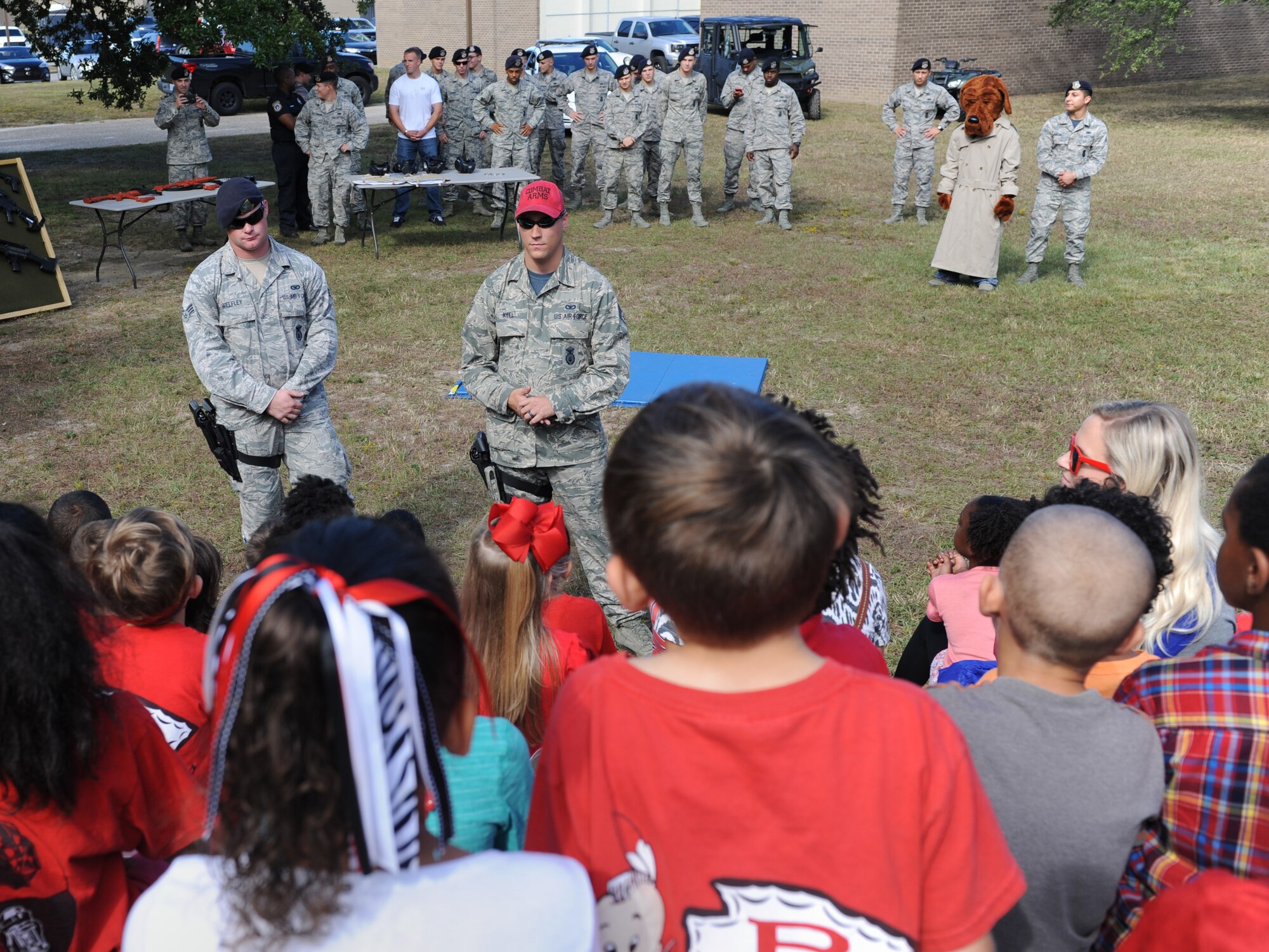 Staff Sgt. Matthew Keel, 81st Security Forces Squadron combat arms instructor, briefs Jeff Davis Elementary School first graders during a field trip Oct. 28, 2016, on Keesler Air Force Base, Miss. The children also toured the Keesler Fire Department where they received a demonstration on the proper wear of firefighter bunker gear and fire prevention safety information. (U.S. Air Force photo by Kemberly Groue/Released)