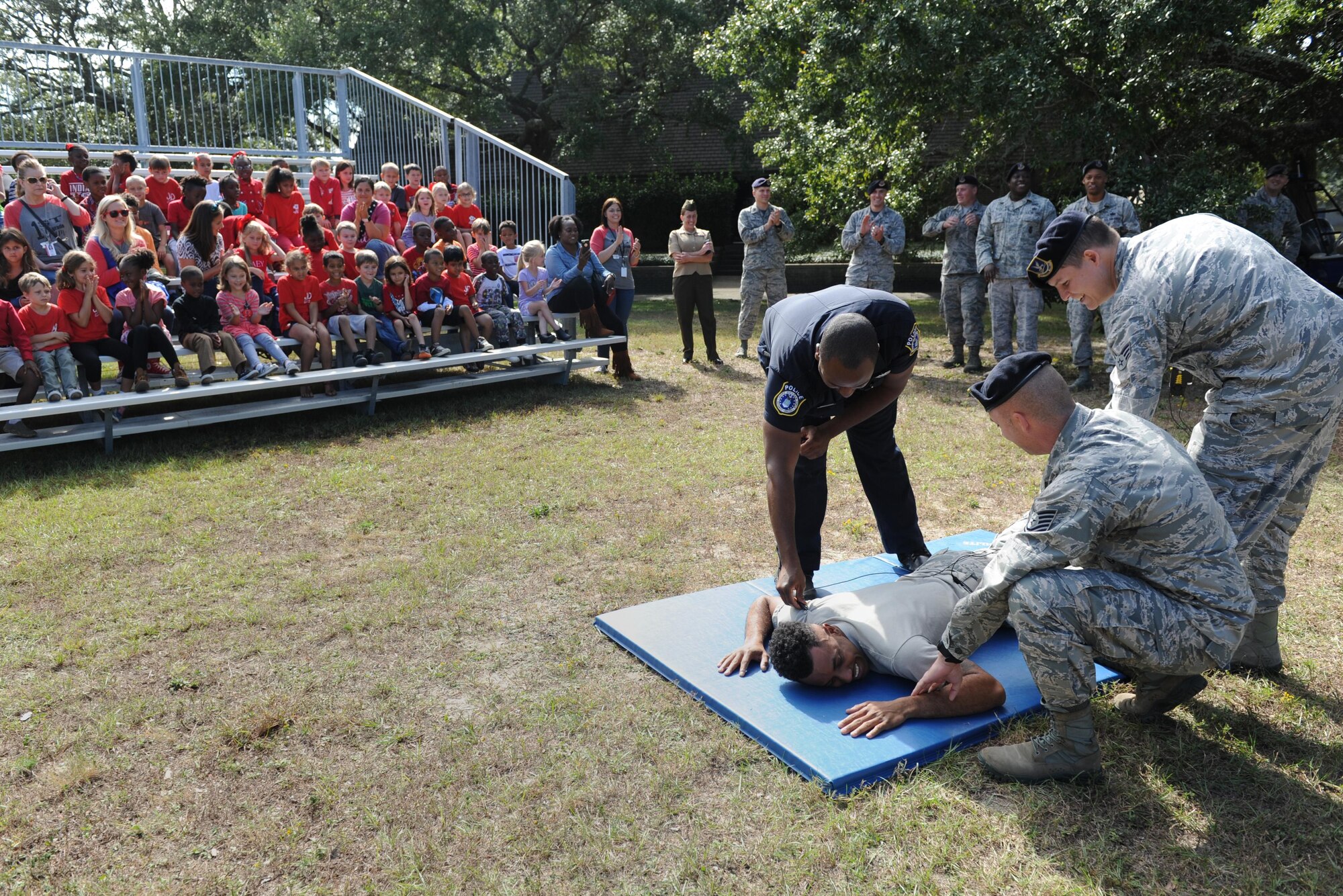 Members of the 81st Security Forces Squadron provide a tazing demonstration to Jeff Davis Elementary School first graders during a field trip to the 81st SFS Oct. 28, 2016, on Keesler Air Force Base, Miss. The children also toured the Keesler Fire Department where they received a demonstration on the proper wear of firefighter bunker gear and fire prevention safety information. (U.S. Air Force photo by Kemberly Groue/Released)