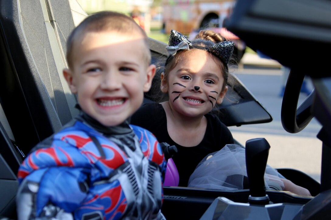 Cayden, 4, left, and Audrey, 4, smile for a photo during a Trunk or Treat event aboard Marine Corps Air Station Cherry Point, N.C., Oct. 27, 2016. Marine Corps Community Services hosted the Halloween-inspired event that included face painting; touch the truck displays; and a family glow dance party. Decorated trunks were judged and the highest-rated contestants received door prizes. (U.S. Marine Corps photo by Cpl. Jason Jimenez/Released)