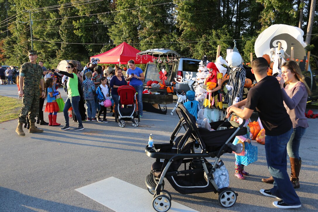 Community members enjoy the displays during a Trunk or Treat event aboard Marine Corps Air Station Cherry Point, N.C., Oct. 27, 2016. Marine Corps Community Services hosted the Halloween-inspired event that included face painting; touch the truck displays; and a family glow dance party. Decorated trunks were judged and the highest-rated contestants received door prizes. (U.S. Marine Corps photo by Cpl. Jason Jimenez/Released)