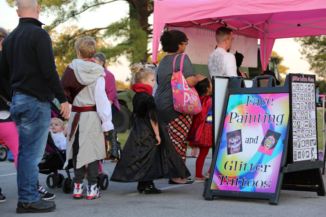 Community members wait in line to get their faces painted during a Trunk or Treat event aboard Marine Corps Air Station Cherry Point, N.C., Oct. 27, 2016. Marine Corps Community Services hosted the Halloween-inspired event that included face painting; touch the truck displays; and a family glow dance party. Decorated trunks were judged and the highest-rated contestants received door prizes. (U.S. Marine Corps photo by Cpl. Jason Jimenez/Released)