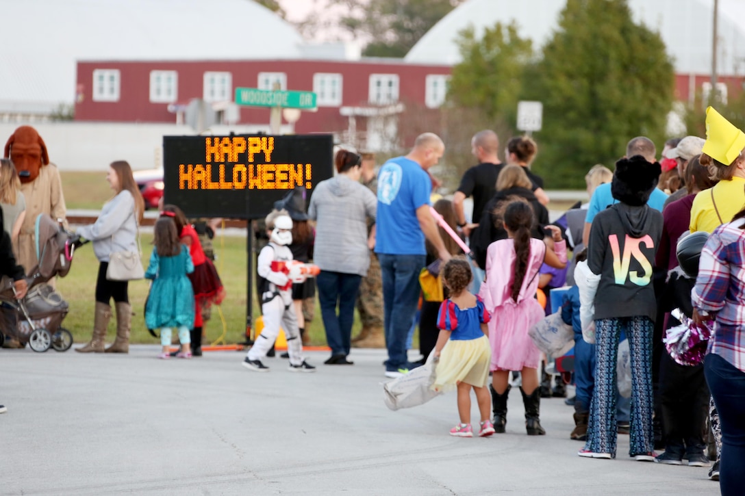 Community members wait in line to view decorated trunks during a Trunk or Treat event aboard Marine Corps Air Station Cherry Point, N.C., Oct. 27, 2016. Marine Corps Community Services hosted the Halloween-inspired event that included face painting; touch the truck displays; and a family glow dance party. Decorated trunks were judged and the highest-rated contestants received door prizes. (U.S. Marine Corps photo by Cpl. Jason Jimenez/Released)