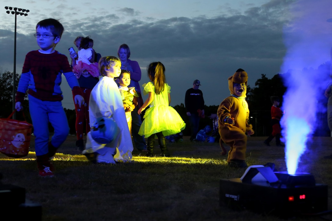 Children enjoy a family glow dance party during a Trunk or Treat event aboard Marine Corps Air Station Cherry Point, N.C., Oct. 27, 2016. Marine Corps Community Services hosted the Halloween-inspired event that included face painting; touch the truck displays; and a family glow dance party. Decorated trunks were judged and the highest-rated contestants received door prizes. (U.S. Marine Corps photo by Cpl. Jason Jimenez/Released)