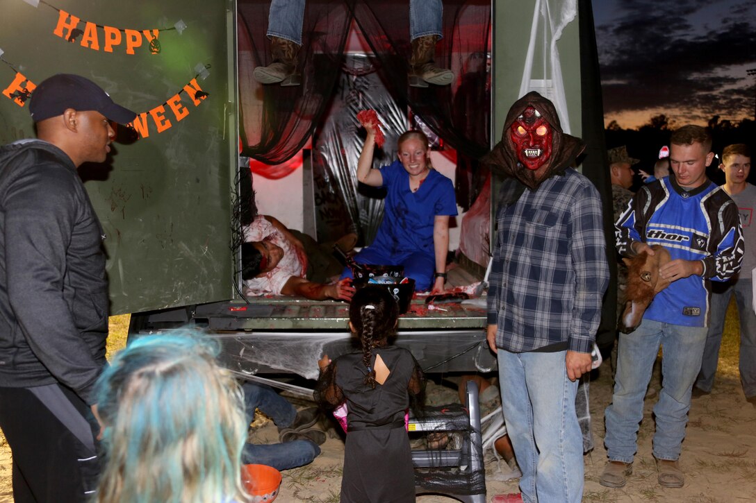 Marines display their decorated display during a Trunk or Treat event aboard Marine Corps Air Station Cherry Point, N.C., Oct. 27, 2016. Marine Corps Community Services hosted the Halloween-inspired event that included face painting; touch the truck displays; and a family glow dance party. Decorated trunks were judged and the highest-rated contestants received door prizes. (U.S. Marine Corps photo by Cpl. Jason Jimenez/Released)