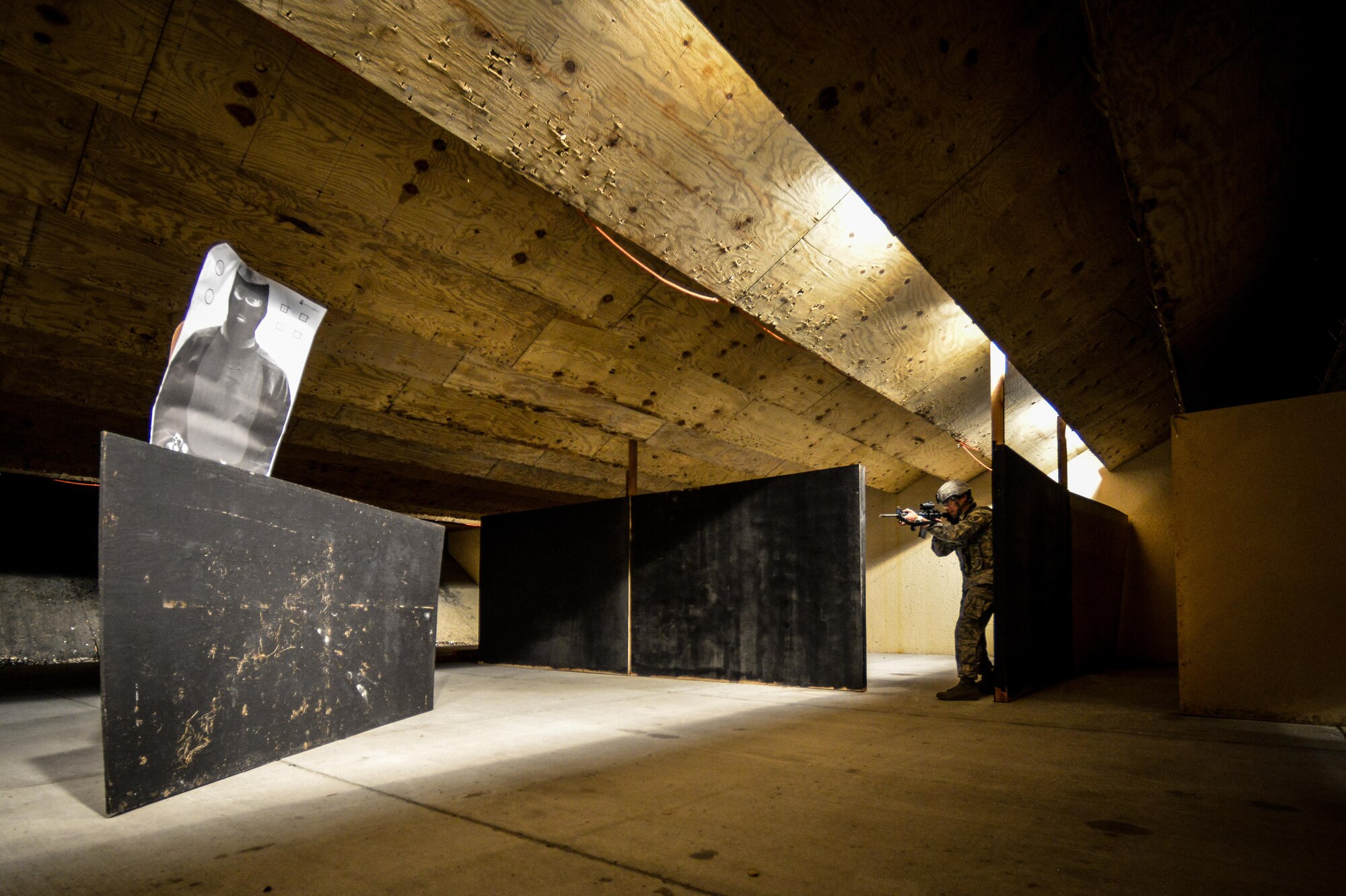 An Airman assigned to the 65th Security Forces Squadron simulates securing a room at Lajes Field, Azores, Portugal, Oct. 5, 2016. Leaders from the 86th Airlift Wing, at Ramstein Air Base, Germany, visited Airmen at Lajes to thank them for their service and tour the base. (U.S. Air Force photo by Senior Airman Nicole Keim) 