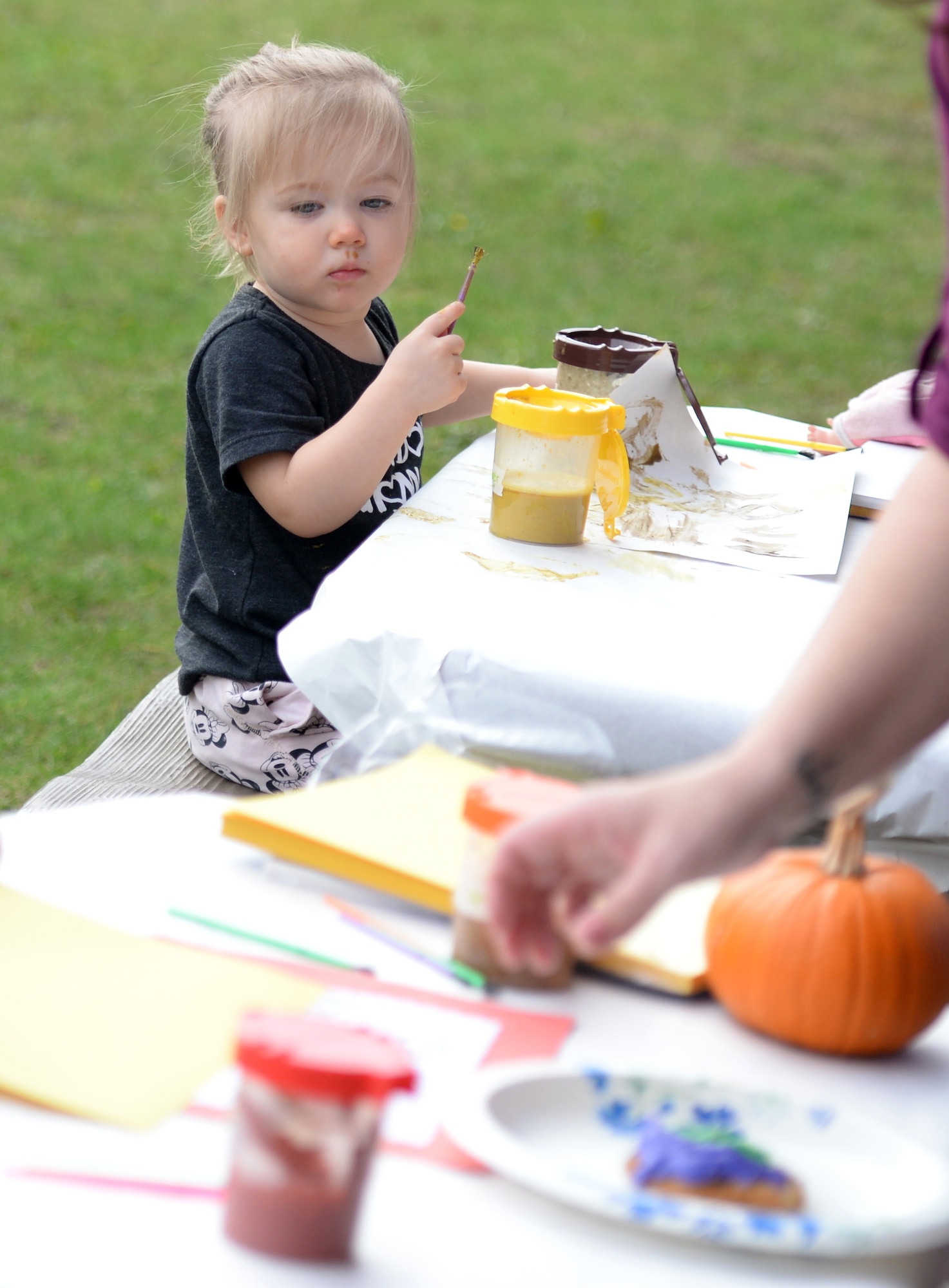 Team Mildenhall children paint fall pictures during a Fall Festival Oct. 28, 2016, at the child development center on RAF Mildenhall, England. Children and parents dressed in costumes and took part in games and activities. (U.S. Air Force photo by Gina Randall)