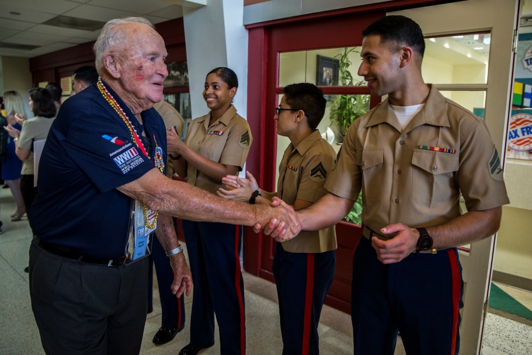 Corporal Mauricio E. Reyes, aviation transportation coordination office clerk, 4th Marine Aircraft Wing, greets World War II veterans as they arrive at Louis Armstrong New Orleans International Airport on a Soaring Valor Honor Flight, Oct. 27, 2016. In 2015, the Gary Sinise Foundation launched the Soaring Valor Honor Flight program with the National WWII Museum, with the goal of preserving each veteran’s first-person account of the war. Each time a flight arrives, Marines from Marine Corps Support Facility New Orleans welcome the veterans to recognize their service to the nation. (U.S. Marine Corps photo by Cpl. Melissa Martens/ Released) 