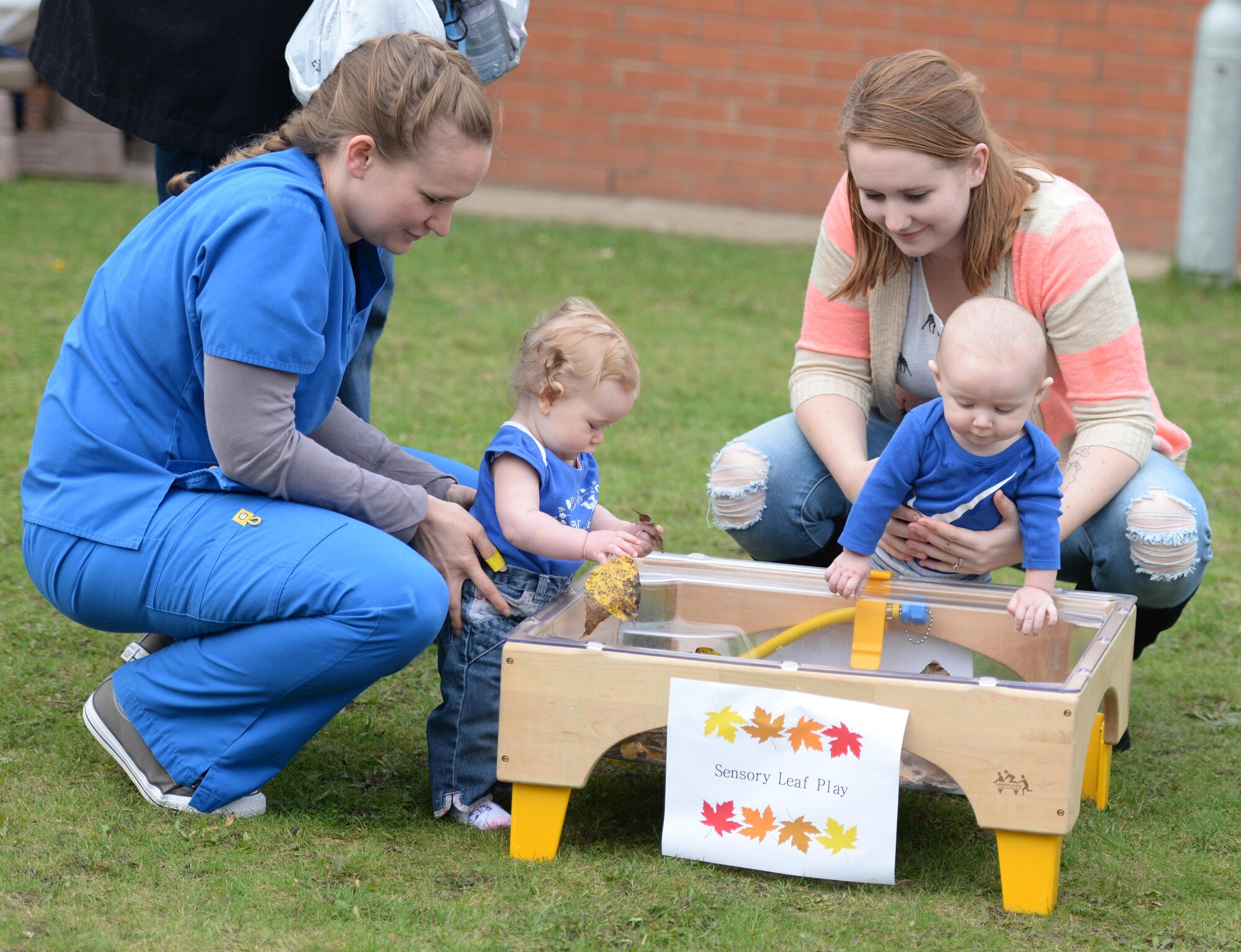 Team Mildenhall children visit the sensory leaf play area during a Fall Festival Oct. 28, 2016, at the child development center on RAF Mildenhall, England. Children took part in a parade then had the opportunity to play with and paint leaves. (U.S. Air Force photo by Gina Randall)