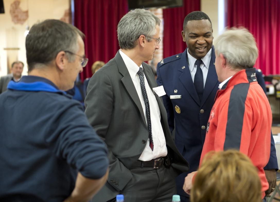 Col. Alfred K. Flowers, Jr., 52nd Medical Group commander, Spangdahlem Air Base, Germany, greets a group of German doctors on base at the Brick House Oct. 27 during the 52nd MDG’s first executive-level Eifel Health Consortium. Spangdahlem Airmen and their families rely on local doctors for specialty healthcare. The event brought more than 20 German doctors to the base, which allowed them and base medical care providers to discuss respective healthcare capabilities, practices, philosophies, approaches and concerns in an effort to continuously provide trusted care to Spangdahlem families. 