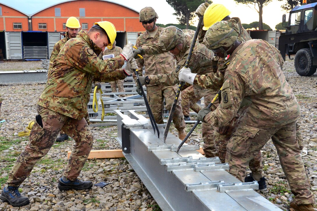 U.S. and Italian soldiers assemble bridge components during exercise Livorno Shock at Leghorn Army Depot in Livorno, Italy, Oct. 21, 2016. Army photo by Elena Baladelli