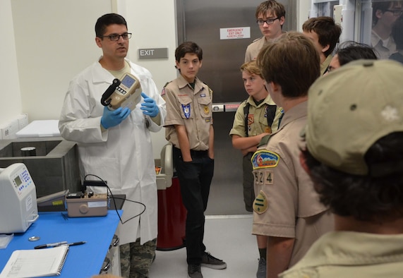 Staff Sgt. Leland La Kemper, a radiochemistry lab technician with the Air Force Technical Applications Center, displays an ion chamber to a group of Boy Scouts who visited AFTAC Oct. 22 to earn their Nuclear Science Merit Badge.  La Kemper explained the importance of ‘as low as reasonably achievable’ – better known as ALARA -- safety measures to the scouts during their tour of AFTAC’s Ciambrone Radiochemistry Lab at Patrick AFB, Fla.  (U.S. Air Force photo by Susan A. Romano)