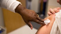 A healthcare professional puts pressure over the site of an injection after providing a flu vaccine to a patient during a community influenza vaccination event held by Naval Hospital Camp Lejeune aboard Marine Corps Base Camp Lejeune. 