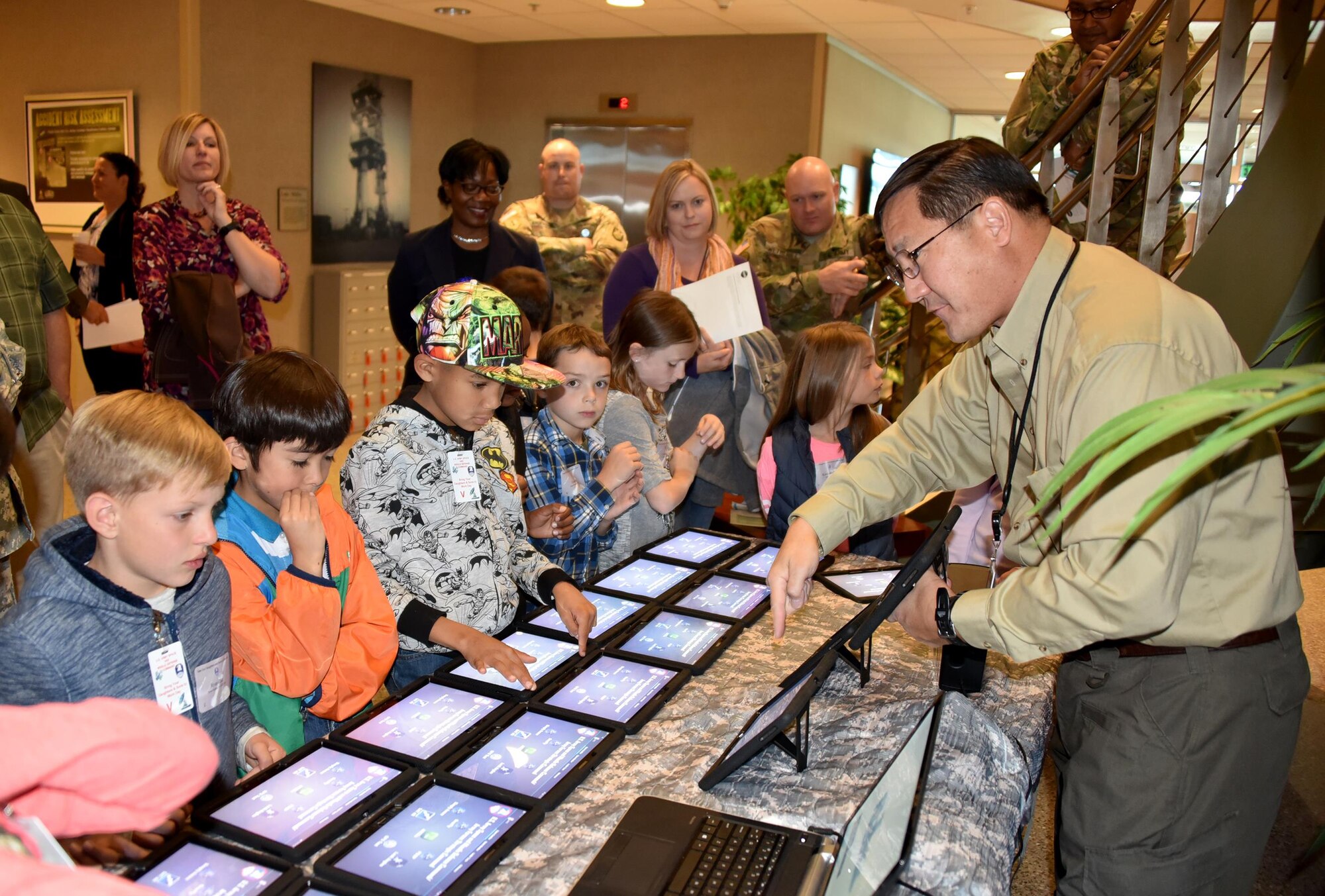 Children of U.S. Army Space and Missile Defense Command/Army Forces Strategic Command employees get a hands-on demonstration of the G31 TREX Space Kits during the command's "Take Our Sons and Daughters to Work" day at Peterson Air Force Base, Colorado, Oct. 21. More than 60 children participated in the event that included a command overview, a briefing from retired Army Astronaut James Voss, demonstrations and displays, a visit to parent's work stations, and a trip to the Space Foundation Discovery Center in Colorado Springs. (Courtesy photo by Dottie White)