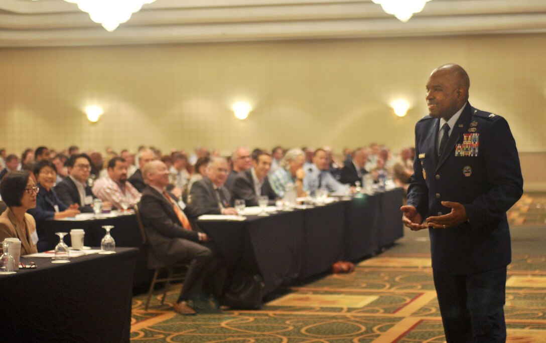 DLA Troop Support Clothing & Textiles Director Air Force Col. Lawrence Hicks, right, briefs representatives from DLA, the U.S. military services and domestic clothing and textiles manufacturers during the 2016 Joint Advanced Planning Brief for Industry October 19, 2016. DLA Troop Support Clothing & Textiles hosted the two-day event to discuss future requirements and business opportunities for military clothing and individual equipment