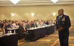 DLA Troop Support Clothing & Textiles Director Air Force Col. Lawrence Hicks, right, briefs representatives from DLA, the U.S. military services and domestic clothing and textiles manufacturers during the 2016 Joint Advanced Planning Brief for Industry October 19, 2016. DLA Troop Support Clothing & Textiles hosted the two-day event to discuss future requirements and business opportunities for military clothing and individual equipment