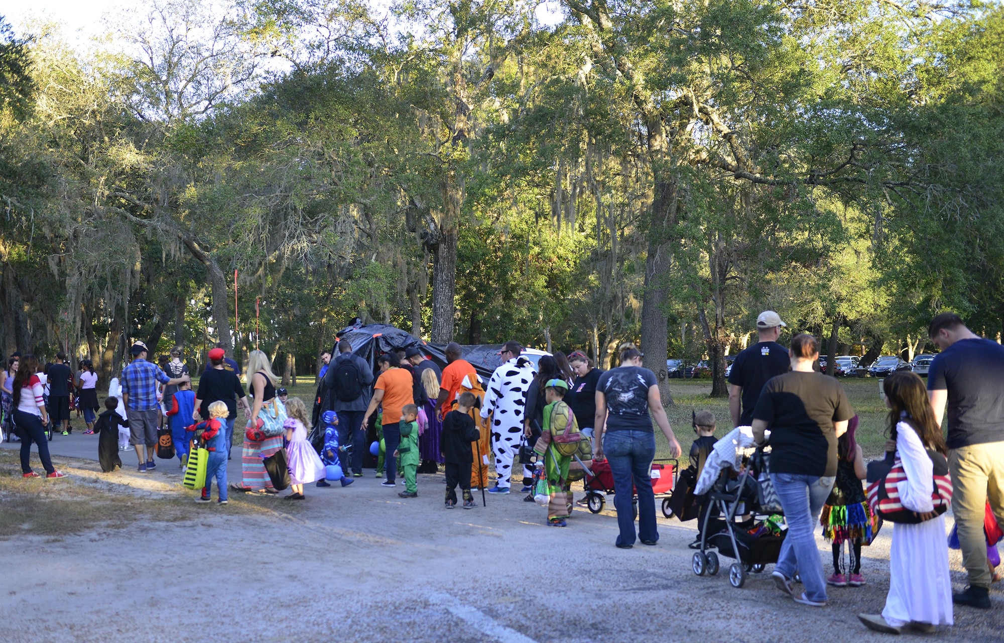 A large crowd moves toward the base’s annual Trunk or Treat event Oct. 28 at Eglin Air Force Base, Fla.  More than 200 parents and children dressed up for the trick or treat event that showcased games and other activities.  (U.S. Air Force photo/Jasmine Porterfield)