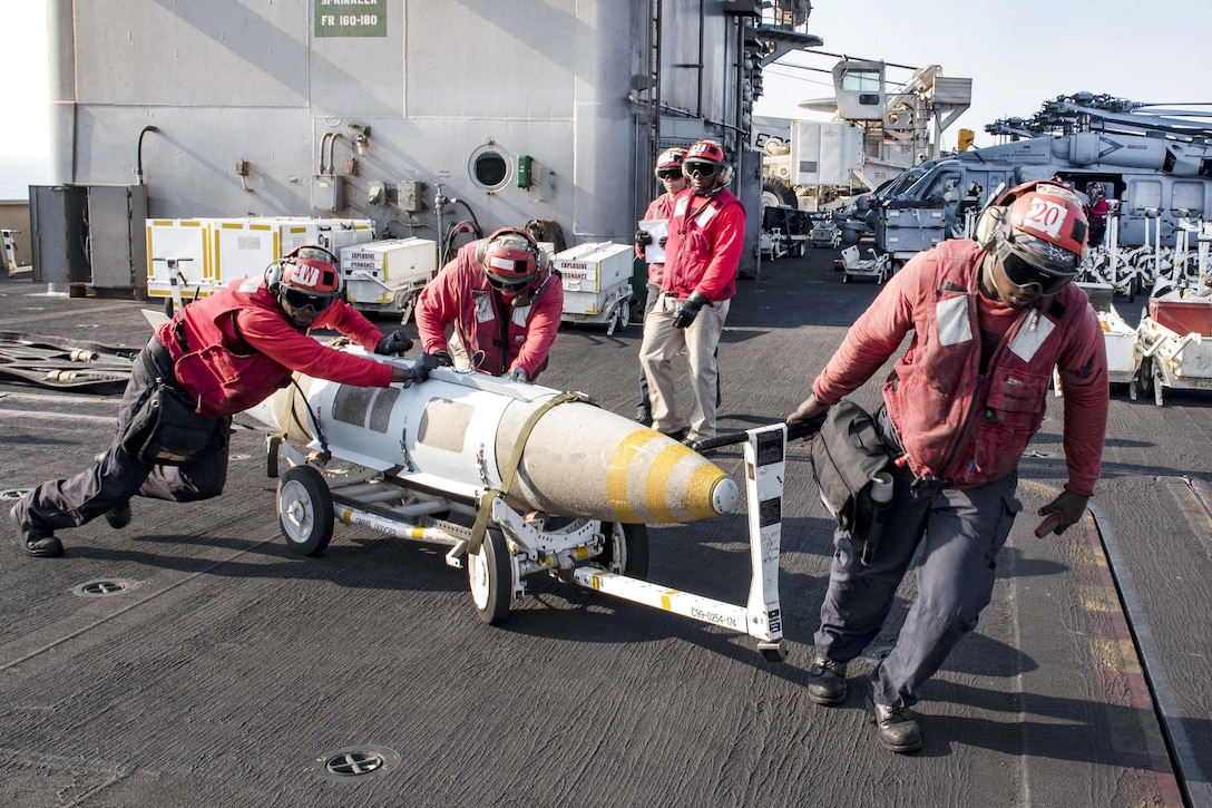 Sailors transport ordnance on the flight deck of the aircraft carrier USS Dwight D. Eisenhower in the Persian Gulf, Oct. 27, 2016. Navy photo by Seaman Joshua Murray