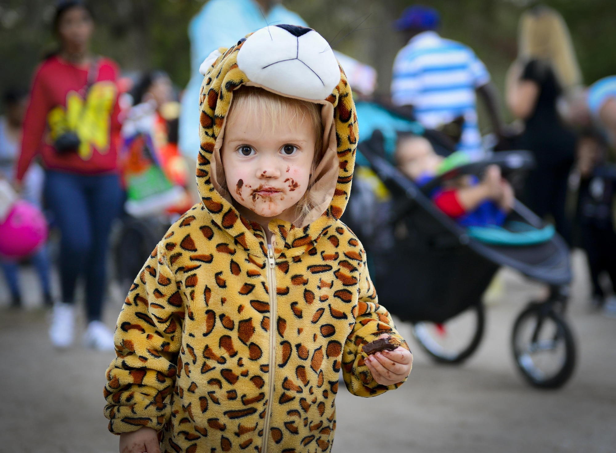 A little leopard really enjoys her candy snack during the base’s annual Trunk or Treat event Oct. 28 at Eglin Air Force Base, Fla.  More than 200 parents and children dressed up for the trick or treat event that showcased games and other activities.  (U.S. Air Force photo/Jasmine Porterfield)