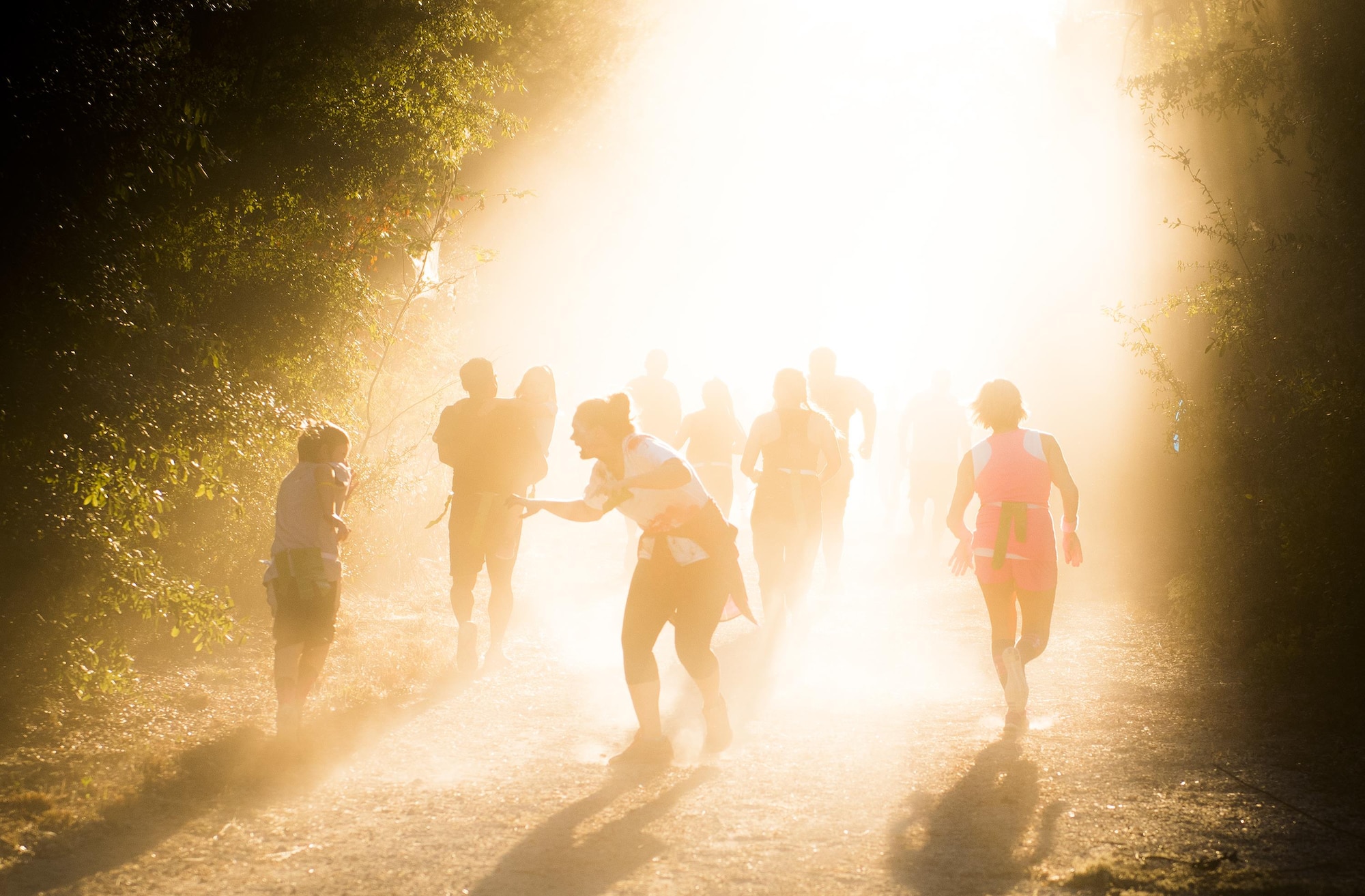 A group of runners try to get past a growling zombie as the sun sets on the annual Zombie Stomp run Oct. 29 at Eglin Air Force Base, Fla.  More than 100 runners participated in ducking, dodging and evading hungry zombies over the 5k course near Base Tango.  (U.S. Air Force photo/Samuel King Jr.)
