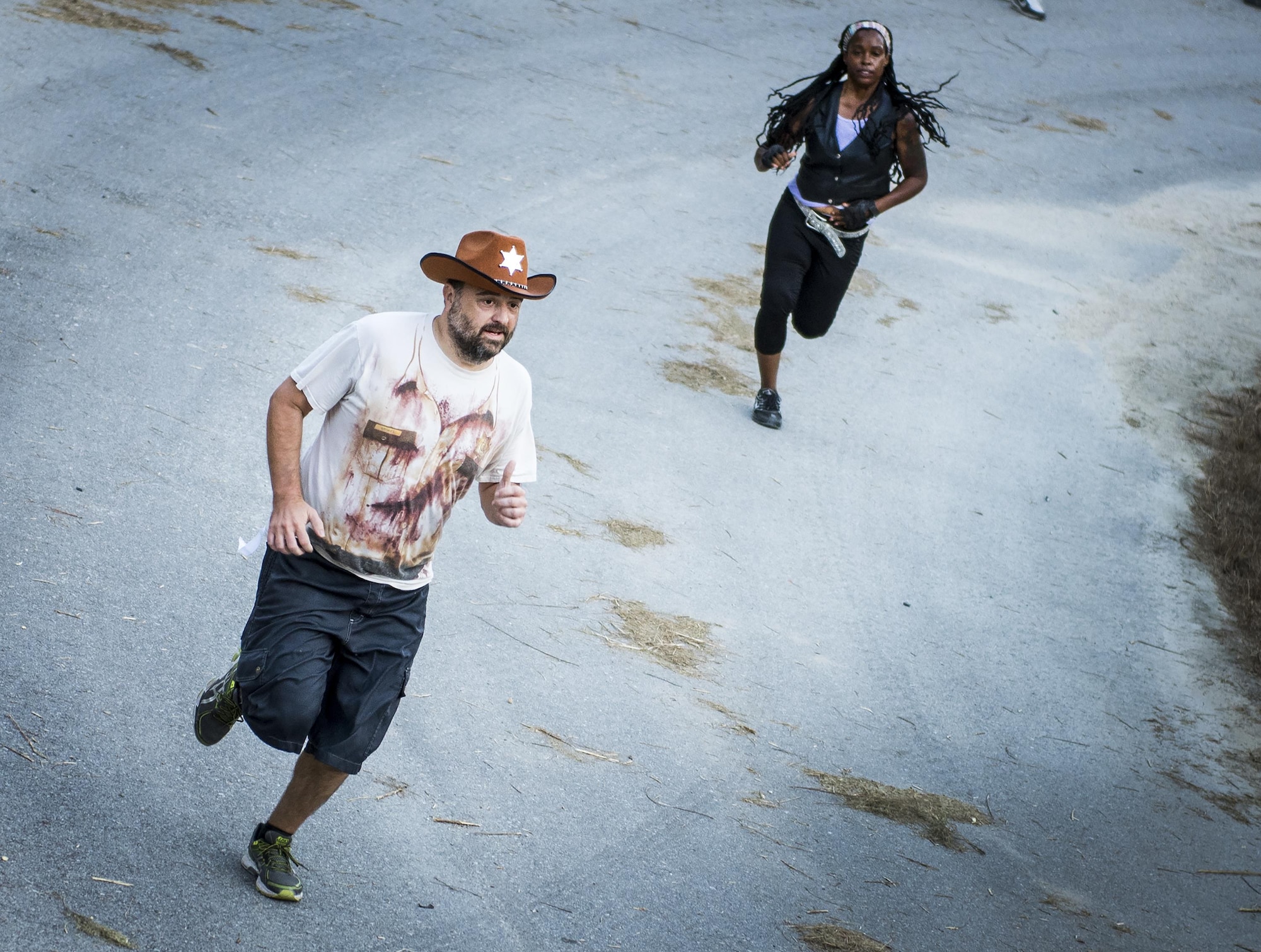 Runners dressed as their favorite “Walking Dead” characters keep an eye out for the next attack during the annual Zombie Stomp run Oct. 29 at Eglin Air Force Base, Fla.  More than 100 runners participated in ducking, dodging and evading hungry zombies over the 5k course near Base Tango.  (U.S. Air Force photo/Samuel King Jr.)