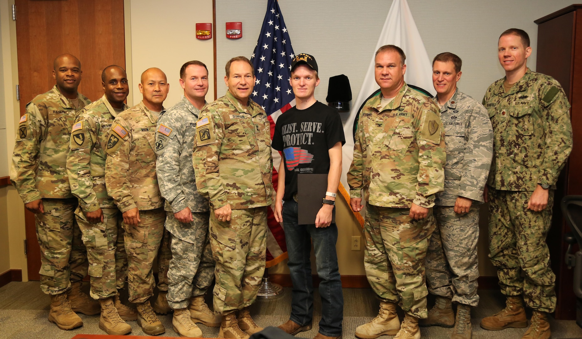 MACDILL AFB, Fla. (October 25, 2016) – U.S. Army Maj. Gen. Edward F. Dorman III, director for logistics, J-4, U.S. Central Command (center left) and his team of CENTCOM engineers welcomed U.S. Army Sgt. Corey M. Robinson (center right) to the headquarters and made him an honorary CENTCOM engineer. Robinson, an ROTC cadet at Tennessee Tech University and a member of the Tennessee National Guard, was involved in a near-fatal motor vehicle accident while transiting to Camp Shelby, Mississippi. He is currently recovering and is dedicating to becoming an Army engineer officer. (U.S. Central Command photo by Marine Sgt. Jordan Belser/ Released)