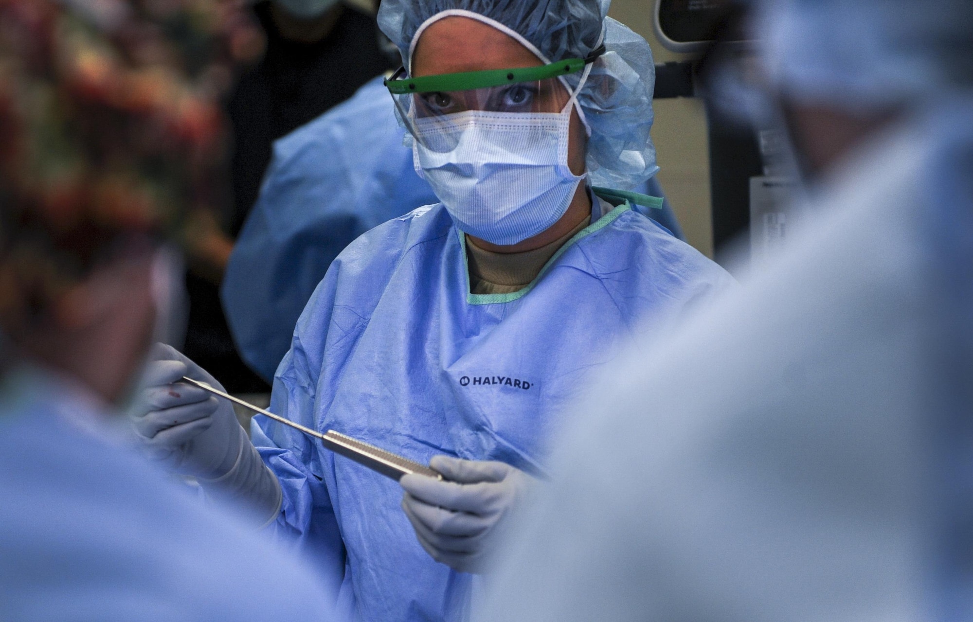 An Airman prepares to hand a surgical instrument to the surgeon during an ACL surgery at the Mike O’Callaghan Federal Medical Center at Nellis Air Force Base, Nev., Oct. 17, 2016. The orthopedics unit of the 99th Surgical Operations Squadron performs a variety of surgeries in order to help Airmen return to top-form after being injured. (U.S. Air Force photo by Airman 1st Class Kevin Tanenbaum/Released)