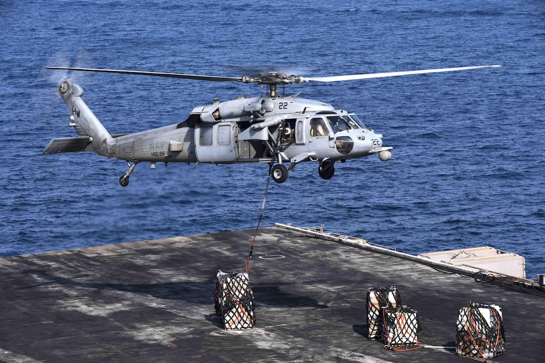 An MH-60S Sea Hawk helicopter assigned to Helicopter Sea Combat Squadron 26 unloads supplies on the flight deck of the aircraft carrier USS Dwight D. Eisenhower during vertical replenishment operations in the Persian Gulf, Oct. 28, 2016. Navy photo by Seaman Christopher A. Michaels
