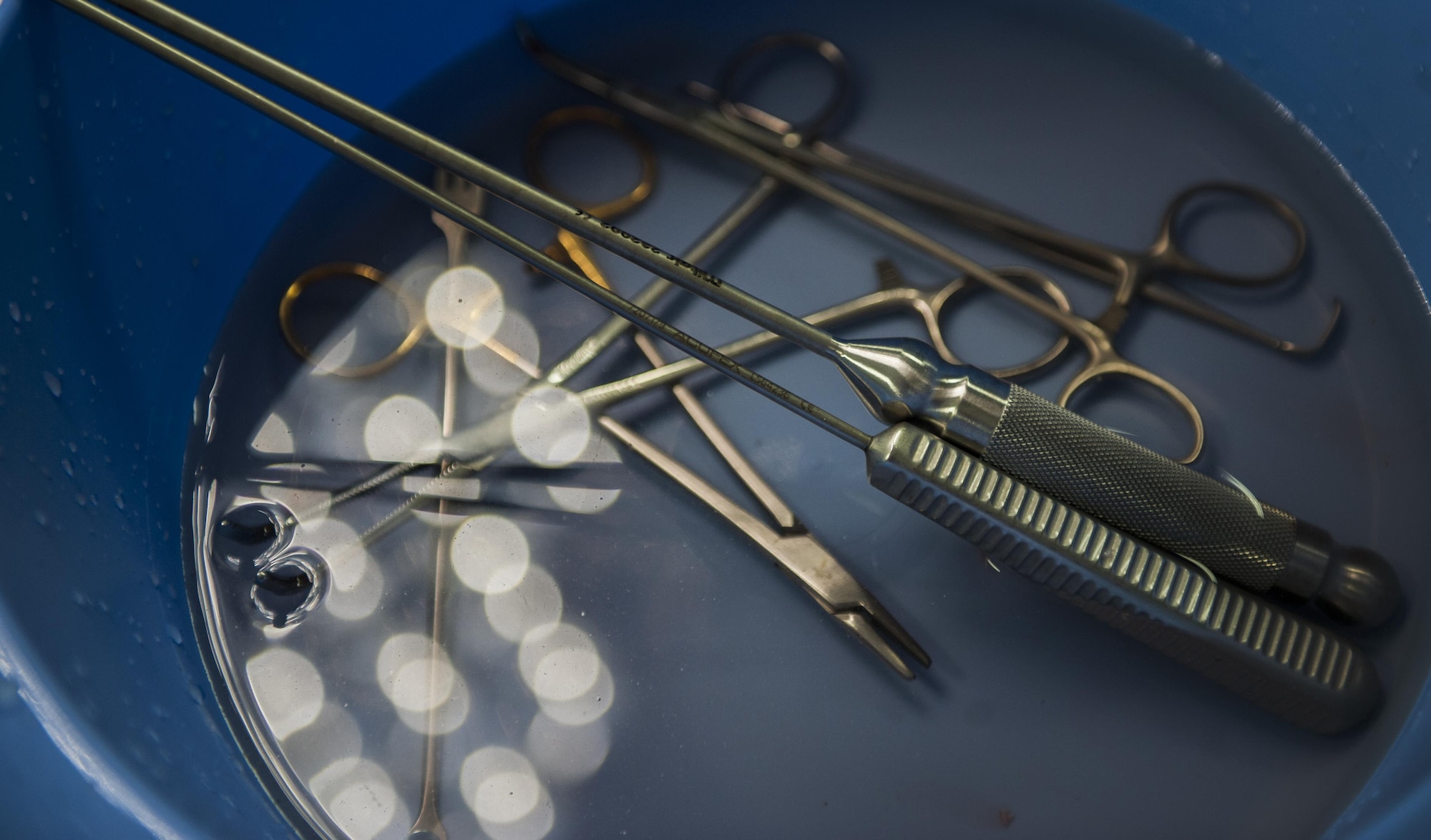 Sterilized surgical instruments sit in a bowl during an ACL surgery at the Mike O’Callaghan Federal Medical Center on Nellis Air Force Base, Nev., Oct. 17, 2016. With surgeons, nurses and technicians working together, the orthopedics unit helps heal Airmen daily to return them to peak form and the mission. (U.S. Air Force photo by Airman 1st Class Kevin Tanenbaum/Released)
