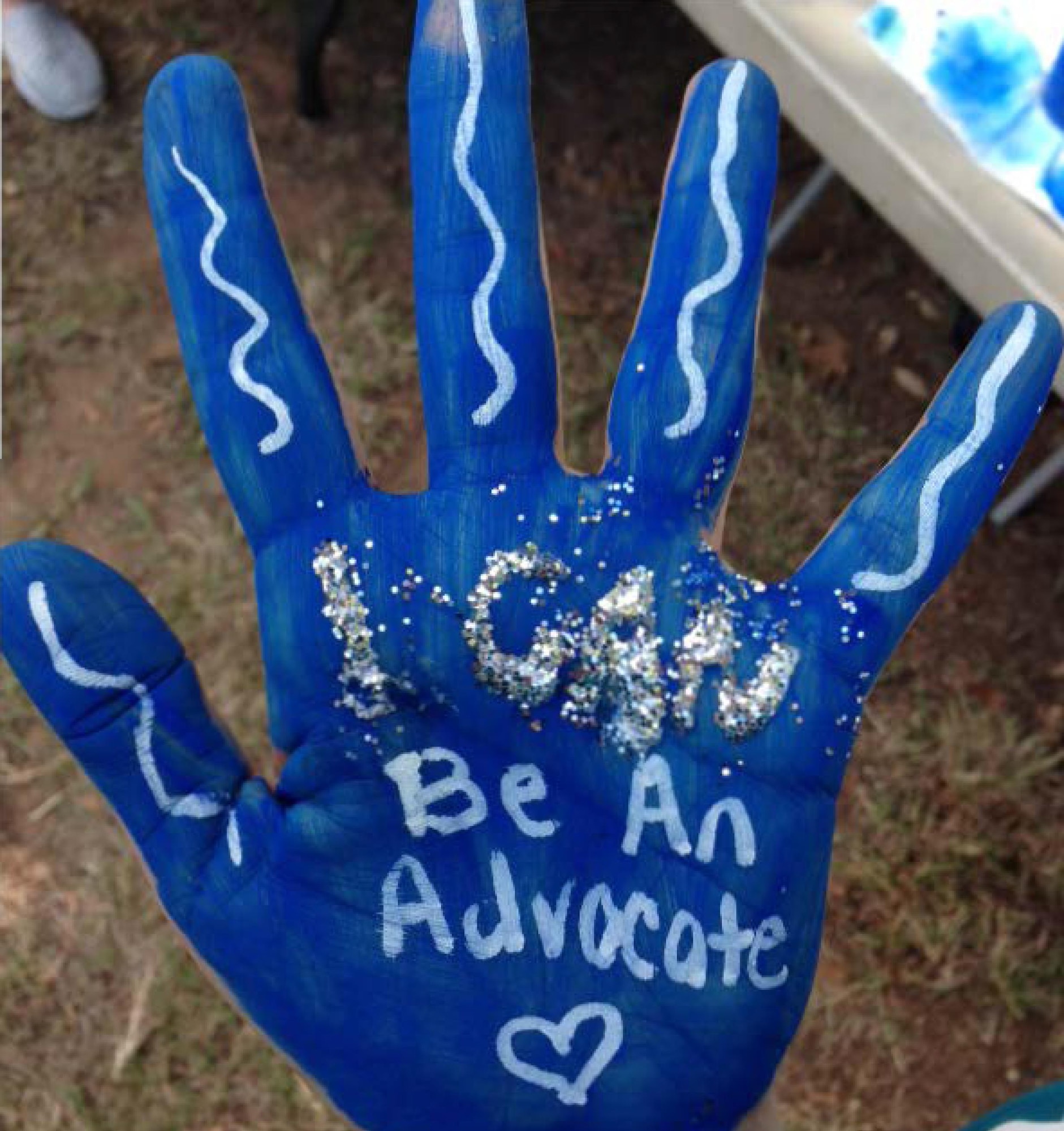 A member from the 301st Fighter Wing participates in the ‘I Can, We Can’ campaign by painting a hand during the 301 FW Family Day to represent a personal commitment to ending domestic violence Oct. 1, 2016. October is Domestic Violence Awareness month, but Airmen were reminded that everyone has a role in ending violence throughout the year. (Courtesy photo)