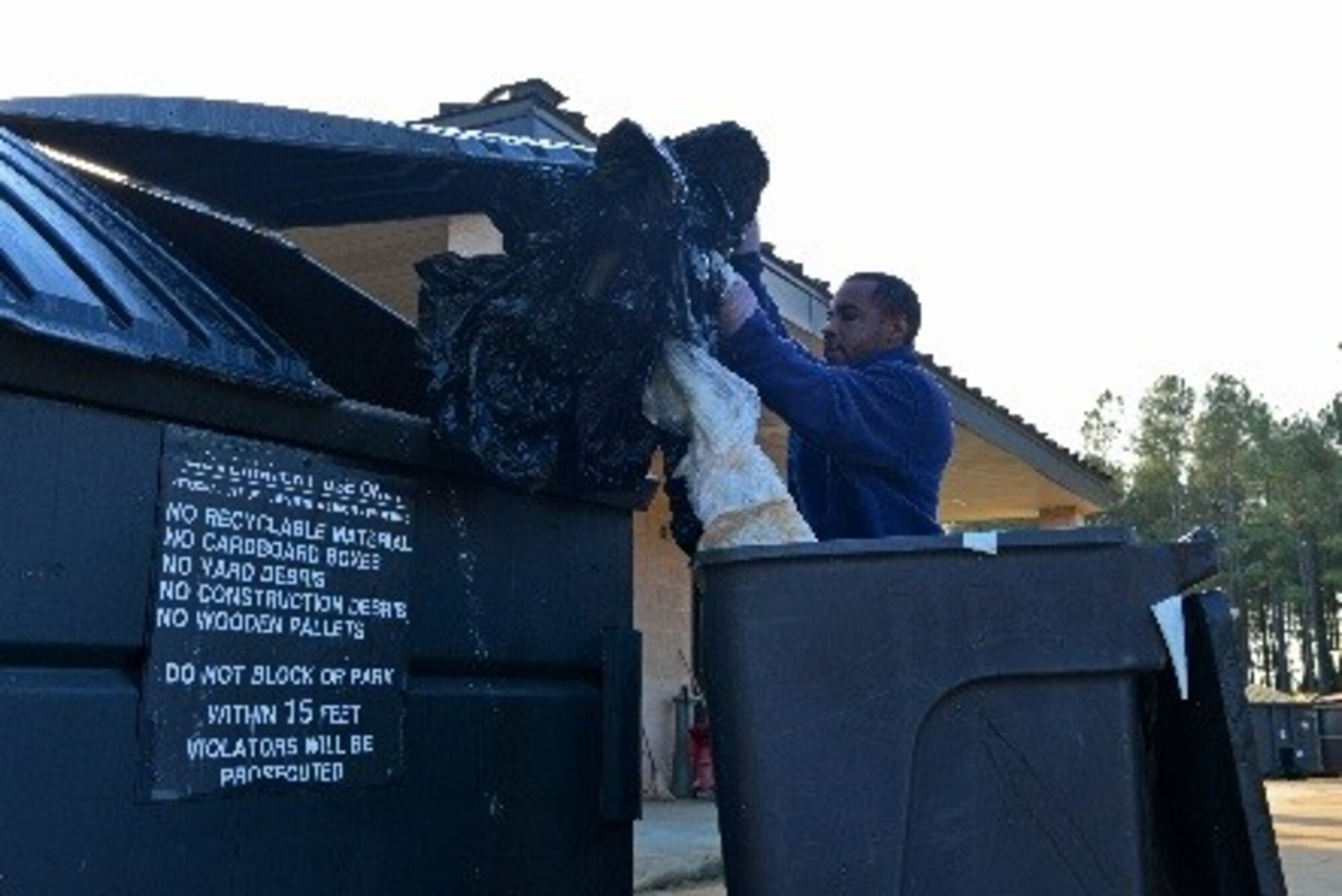 Julious Nichols, Shaw Recycling Center employee, puts used plastic bags into a dumpster at Shaw Air Force Base, S.C., Oct. 28, 2016. Recycling can help prevent pollution to the environment by reducing the need to collect new raw materials for use in production. (U.S. Air Force photo by Airman 1st Class Destinee Sweeney)
