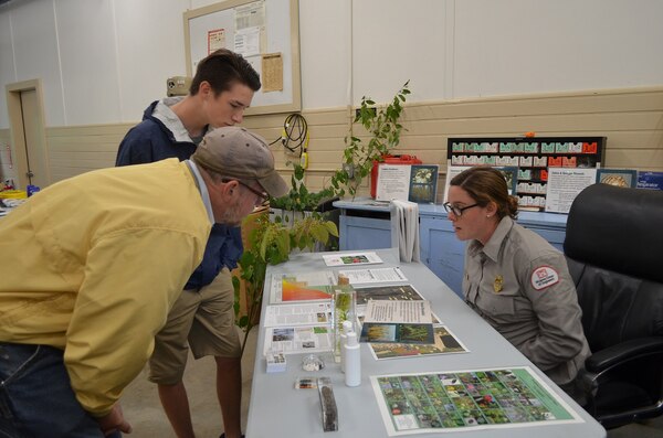 Park Ranger Alicia Lacrosse explains the displays on the table during Surry's 75th anniversary commemoration, October 1, 2016. 