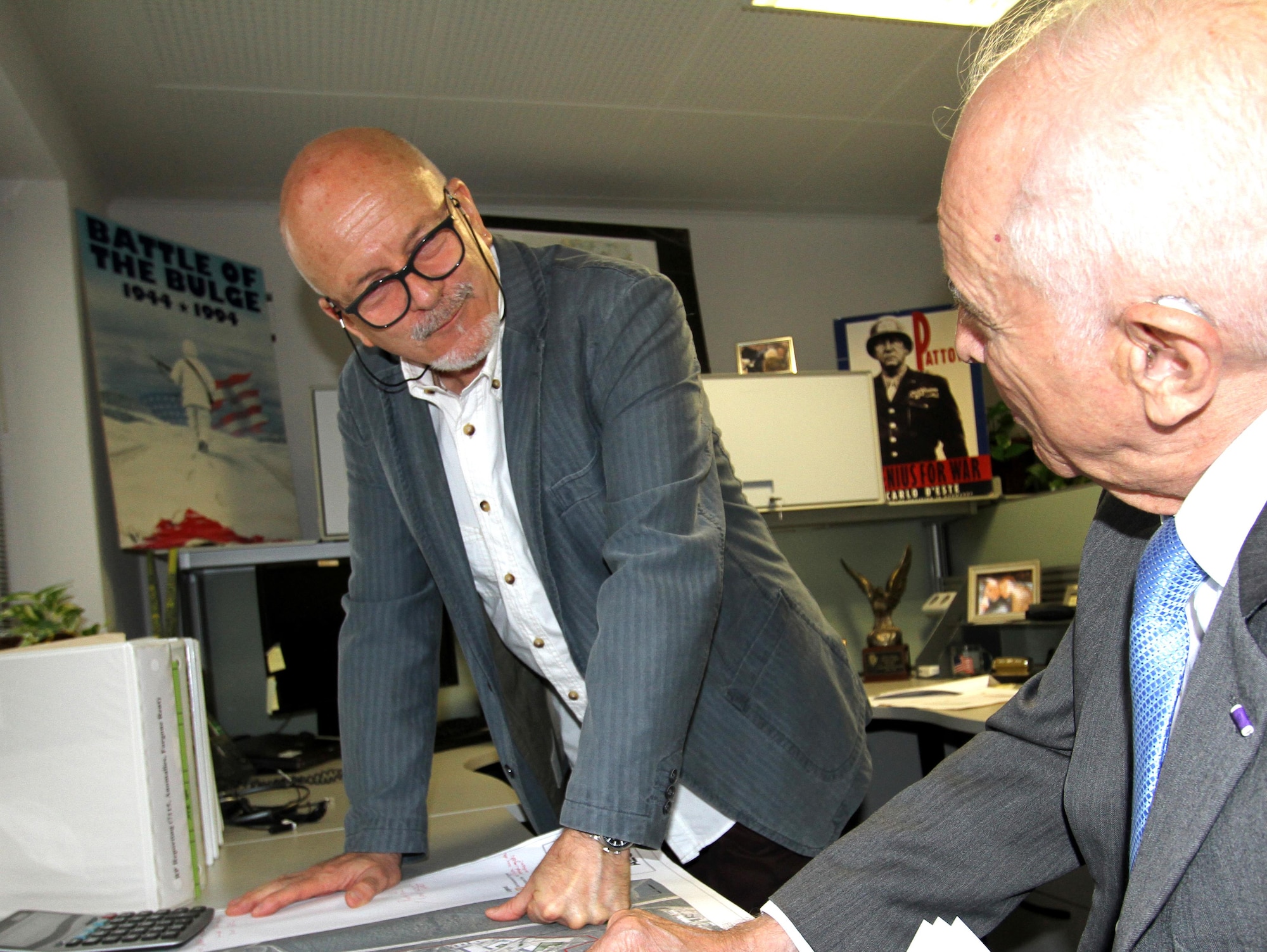 Karl Willi Ningelgen, AFCEC's Europe senior environmental advisor, looks over a base map with coworker Tony Duno. (U.S. Air Force photo/Debbie Aragon)