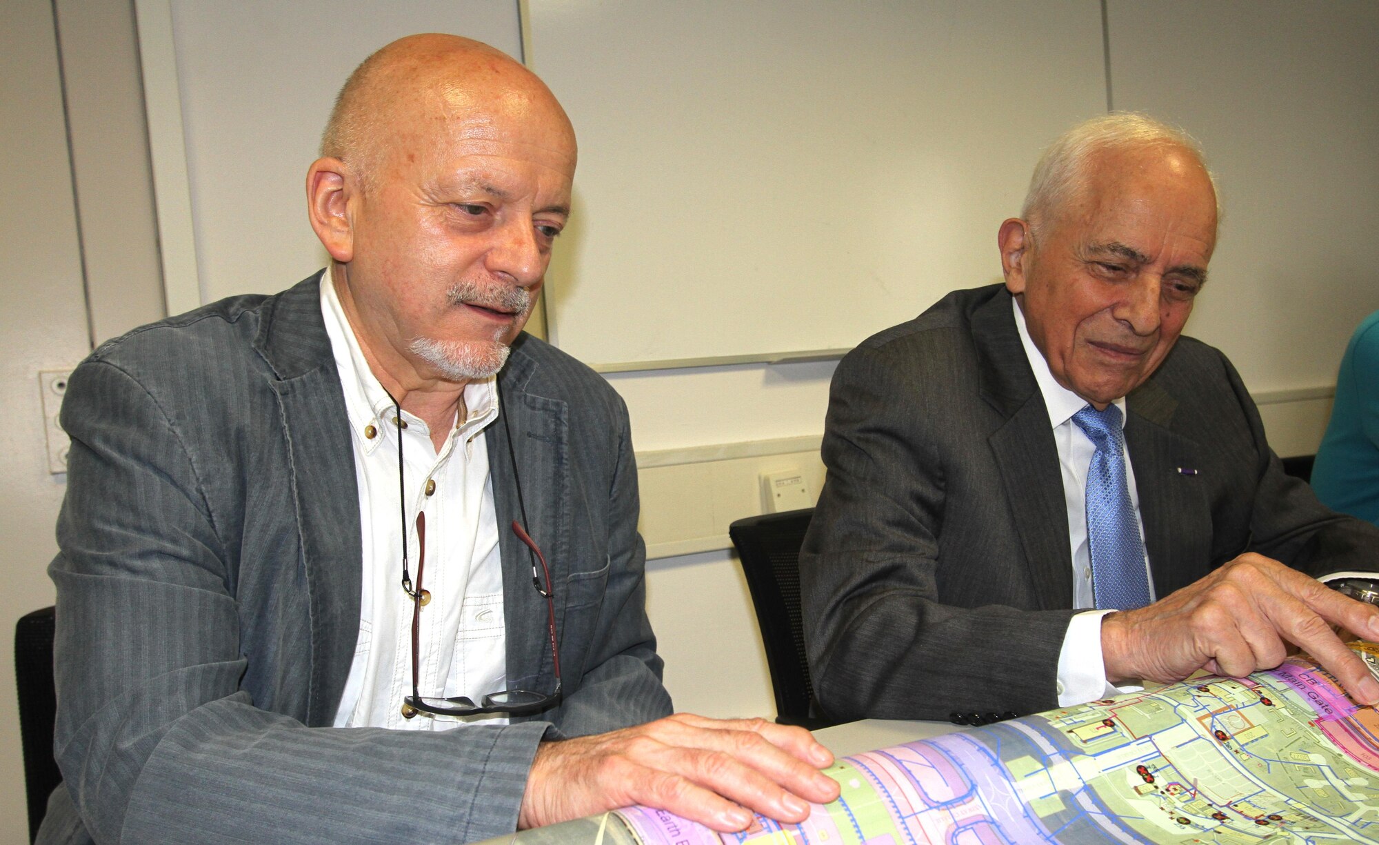 At left, Karl Willi Ningelgen, AFCEC's Europe senior environmental advisor, and his coworker Tony Duno look over a base map during a meeting at Ramstein AB, Germany. (U.S. Air Force photo/Debbie Aragon)