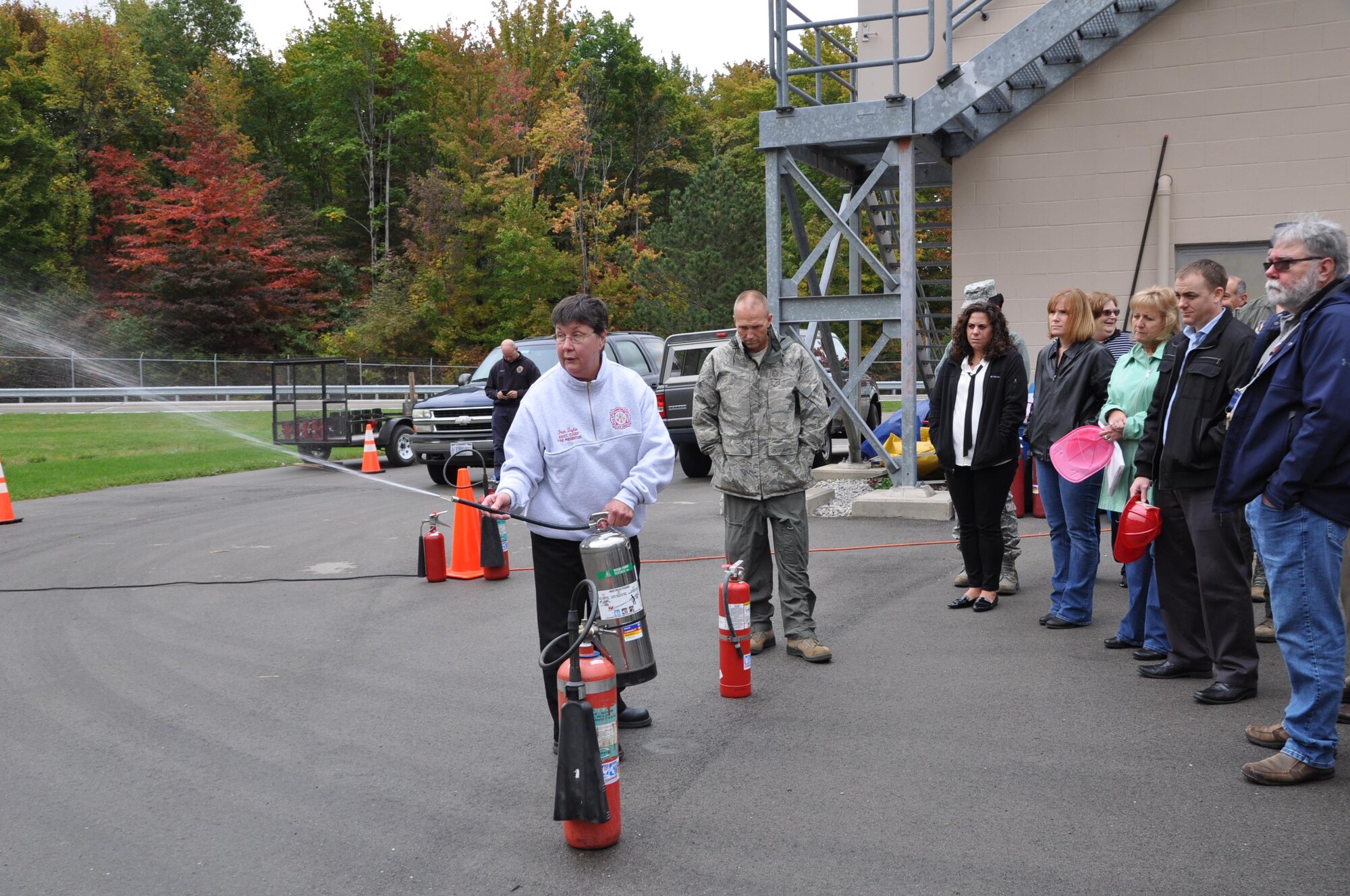 Fran Taylor, 910th Civil Engineer Squadron Fire Department assistant chief of fire prevention, demonstrates a fire extinguisher for members of the 910 Airlift Wing during fire safety training Oct. 13, 2016 here. (U.S. Air Force photo/Maj. Polly Orcutt)