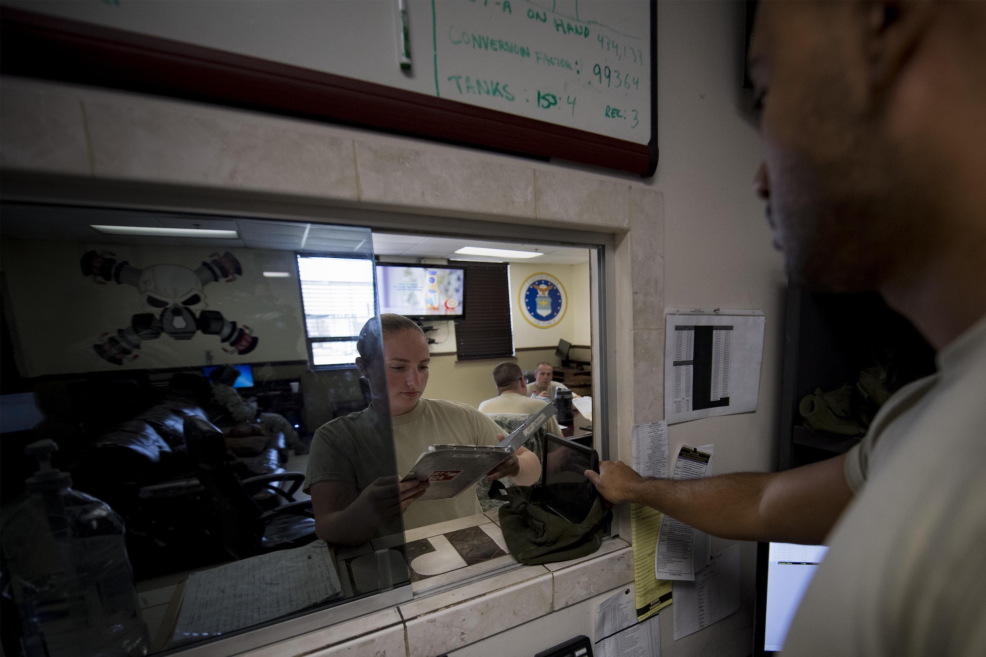 Senior Airman Calvin Rivera, 23d Logistics Readiness Squadron fuels servicing center controller, issues a fuels servicing clipboard and checklist to Airman 1st Class Courtney Herll, 23d LRS fuels distribution operator, Oct. 26, 2016, at Moody Air Force Base, Ga. The fuels service center liaises with the mission operation control center to determine the flying schedule along with aircraft landing times and locations. Even with the schedules, they maintain flexibility to ensure mission requirements are met. (U.S. Air Force photo by Airman 1st Class Daniel Snider)