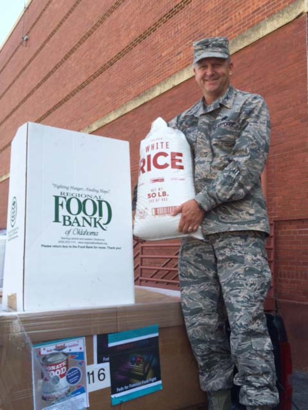Air Force Col.  Ken Ruthardt, Defense Logistics Agency Aviation commander at Oklahoma City, drops off rice at the Regional Food Bank of Oklahoma donation box on Tinker Air Force Base, Oklahoma in support of the Feds Feed Families Program, which runs annually from June through August.  Both DLA Aviation and DLA Distribution supported Feds Feed Families this year by challenging each other to a “food fight” to see who could donate the most food to the program.