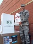 Air Force Col.  Ken Ruthardt, Defense Logistics Agency Aviation commander at Oklahoma City, drops off rice at the Regional Food Bank of Oklahoma donation box on Tinker Air Force Base, Oklahoma in support of the Feds Feed Families Program, which runs annually from June through August.  Both DLA Aviation and DLA Distribution supported Feds Feed Families this year by challenging each other to a “food fight” to see who could donate the most food to the program.