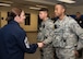 Hanscom Command Chief Master Sgt. Patricia L. Hickey presents her coin to Airman 1st Class Joshua King, right, and Airman 1st Class Christopher Allen, both entry controllers for the 66th Security Forces Squadron, during guard mount at Hanscom Air Force Base, Mass., Oct. 31. Both Airmen were recognized for their duty performance and for volunteering at a recent Combined Federal Campaign event. (U.S. Air Force photo by Mark Herlihy)