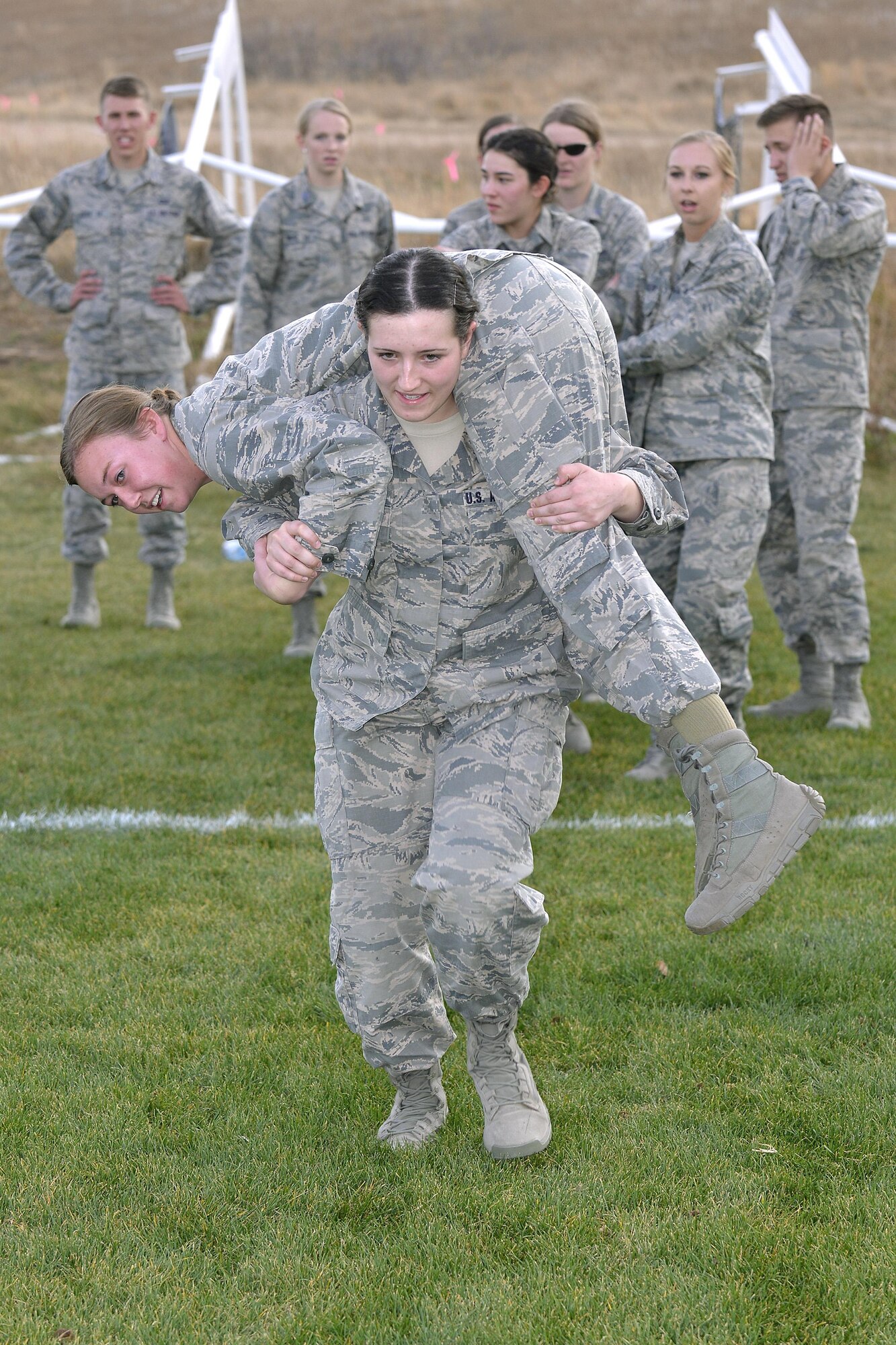A cadet carries another cadet during one of several relays in the Combat Fitness Challenge portion of the Commandant's Challenge, Oct. 28, 2016, at the U.S. Air Force Academy. The Commandant's Challenge is a physically and mentally demanding 48-hour training exercise and contest between the Cadet Wing’s 40 cadet squadrons. (U.S. Air Force photo/Jason Gutierrez) 
