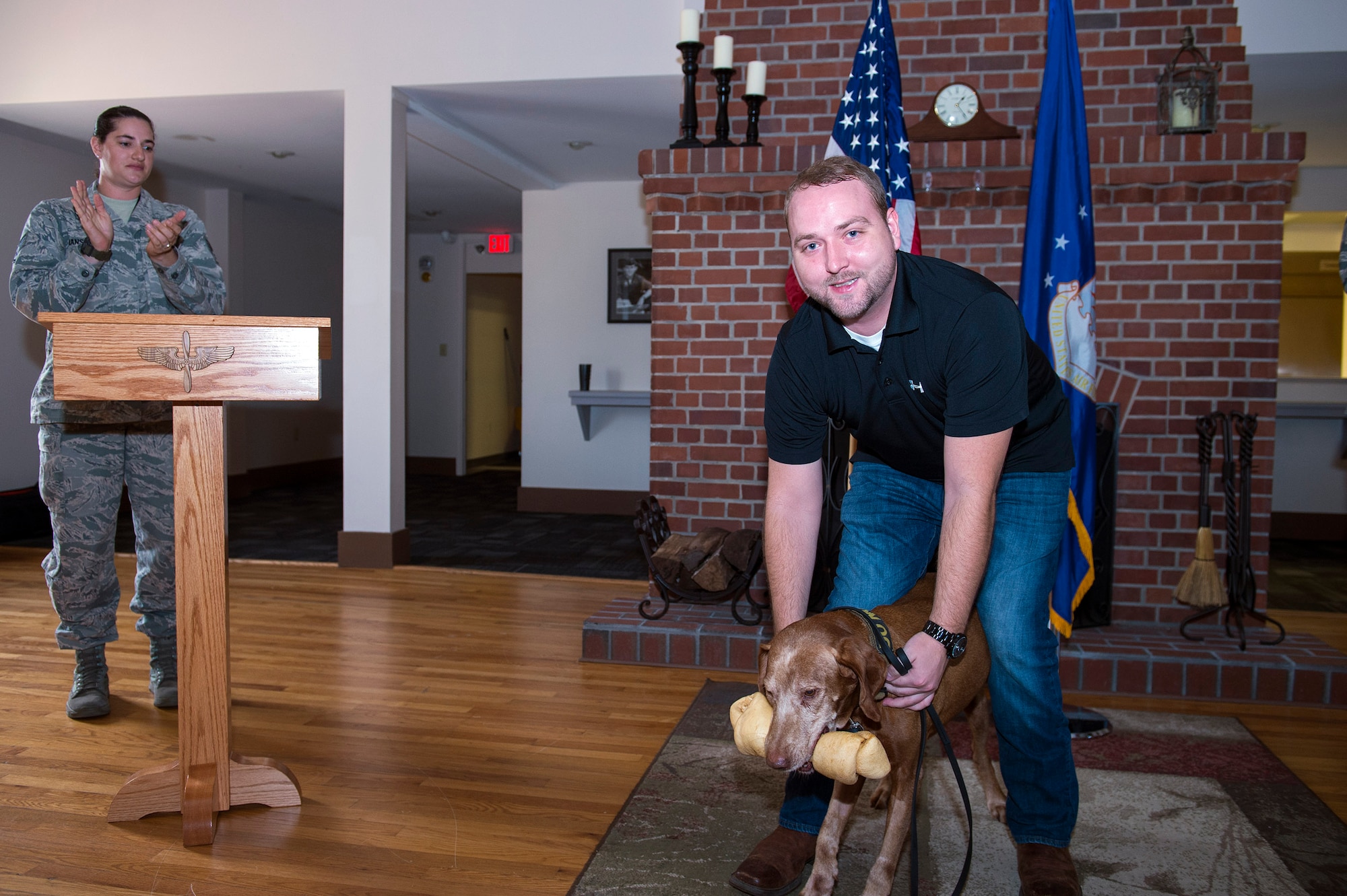 Alexander Nutting, former 23d Security Forces Squadron Military Working Dog handler, poses with retired MWD Dini during his retirement ceremony, Oct. 28, 2016, at Moody Air Force Base, Ga. Nutting and Dini deployed together to Al Udeid Air Base, Qatar, in 2014 in support of Operation Enduring Freedom. (U.S. Air Force photo by Airman 1st Class Greg Nash)