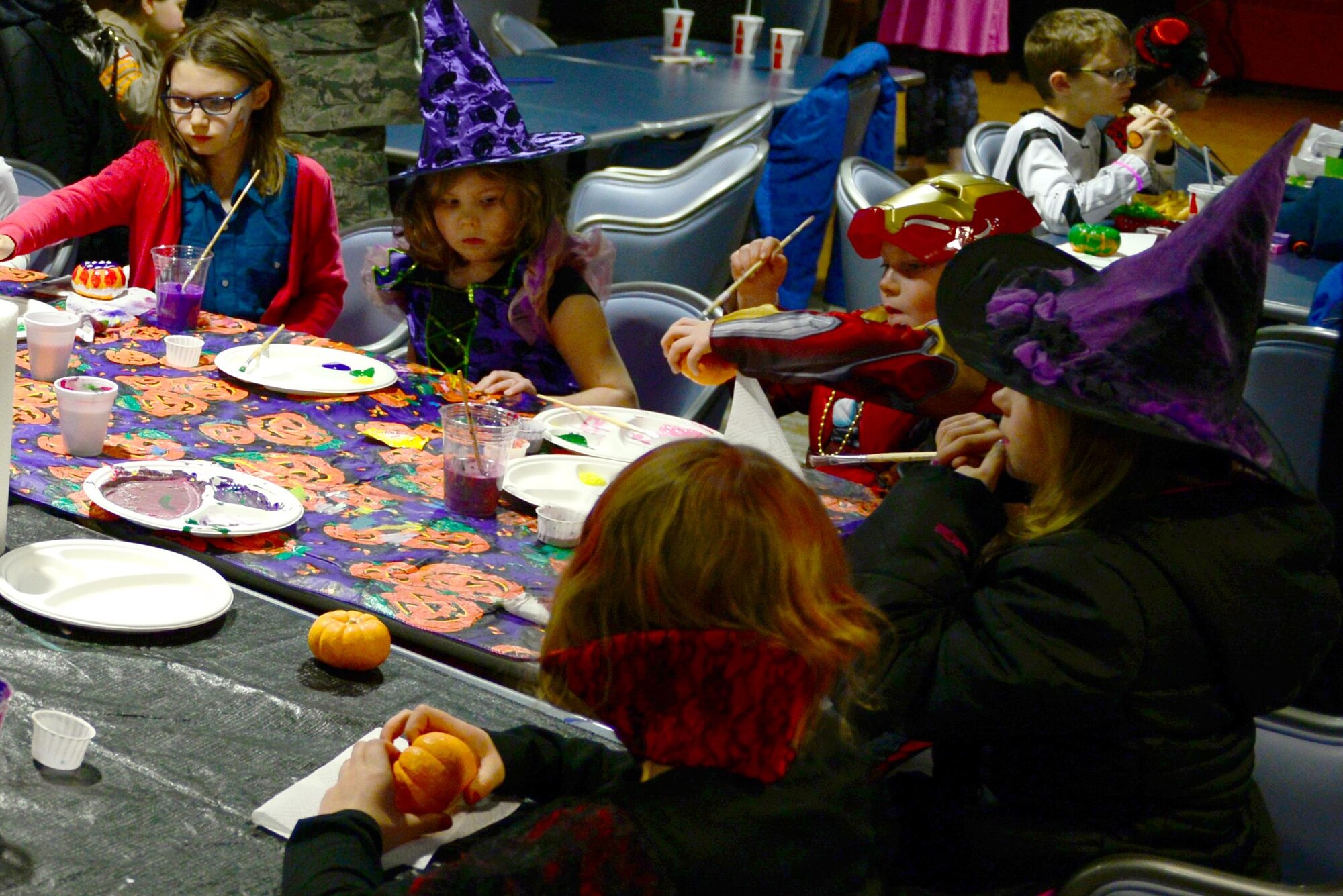 Children paint pumpkins during the 2016 Fall Festival at the Yukon Club, Oct. 28, 2016, at Eielson Air Force Base, Alaska. Pumpkin painting was one of the most popular activities during the festival and allowed children to show their artistic talents. (U.S. Air Force photo by Airman Eric M. Fisher)