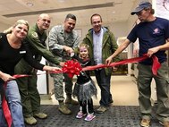 Col. Mathew Fritz, 92 Air Refueling Wing Commander and other members of team Fairchild perform a ribbon cutting reopening the FunSpot at the Triple F Oct. 29, 2016, at Fairchild Air Force Base. On October 6th the original was closed due to constructional concerns but has since been reopened at the Triple F where the 92nd Force Support squadron has been able to provide the majority of the FunSpot services. (Courtesy photo)