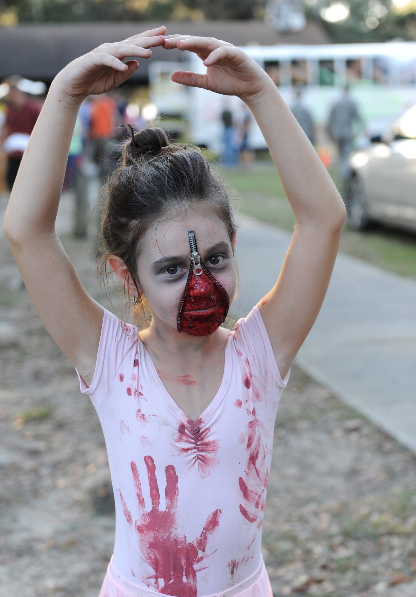 Caitlyn Holden, daughter of Master Sgt. Jeff Holden, 335th Training Squadron precision measurement electronics laboratory training flight NCO in charge, poses for a photo during Ghouls in the Park at Marina Park Oct. 28, 2016, on Keesler Air Force Base, Miss. Ghouls in the Park featured a zombie bus, a haunted house, “Trunk or Treat” and games for children of all ages. (U.S. Air Force photo by Kemberly Groue/Released)