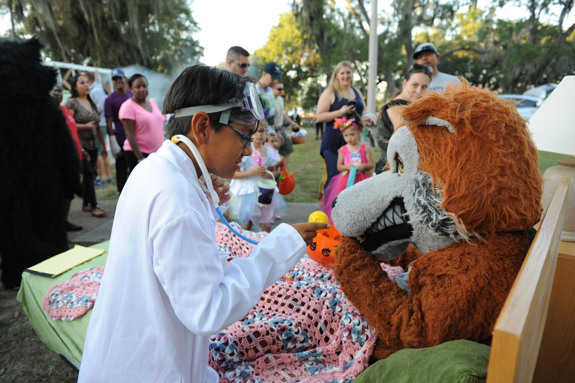 Carlos Hurtado Jr., son of retired Master Sgt. Carlos Hurtado Sr., portrays a doctor as he checks the vital signs of the 336th Training Squadron red wolf mascot during Ghouls in the Park at Marina Park Oct. 28, 2016, on Keesler Air Force Base, Miss. Ghouls in the Park featured a zombie bus, a haunted house, “Trunk or Treat” and games for children of all ages. (U.S. Air Force photo by Kemberly Groue/Released)