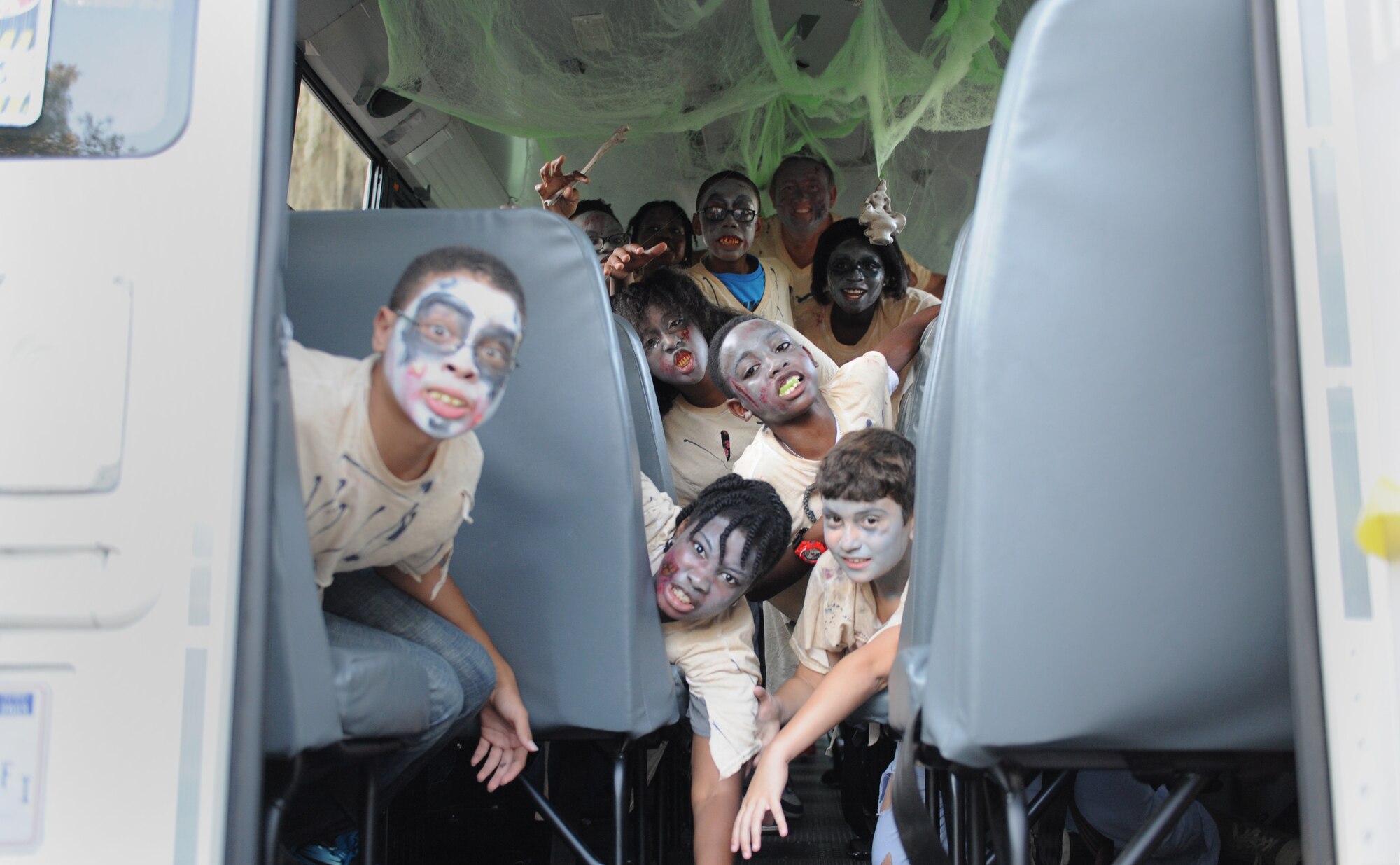 Keesler Youth Center volunteers get into character aboard the zombie bus during Ghouls in the Park at Marina Park Oct. 28, 2016, on Keesler Air Force Base, Miss. Ghouls in the Park also featured a haunted house, “Trunk or Treat” and games for children of all ages. (U.S. Air Force photo by Kemberly Groue/Released)