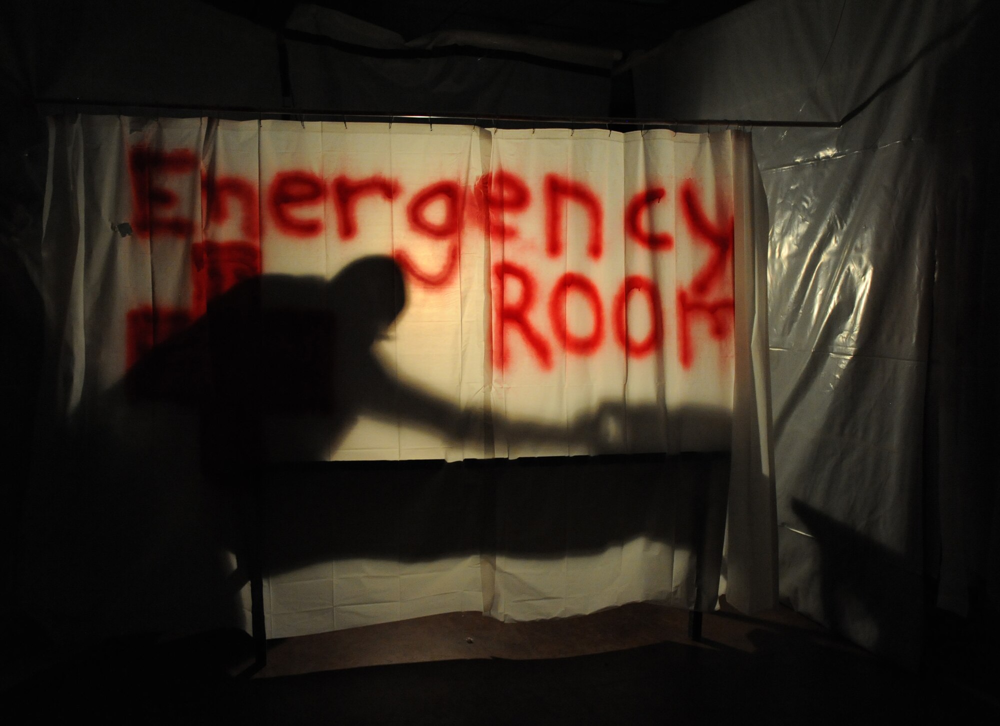 Volunteers act out a scary scene in the haunted house during Ghouls in the Park at Marina Park Oct. 28, 2016, on Keesler Air Force Base, Miss. Ghouls in the Park also featured a zombie bus, “Trunk or Treat” and games for children of all ages. (U.S. Air Force photo by Kemberly Groue/Released)