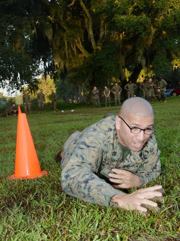 Staff Sgt. Noe Vega, assistant operations chief, Military Operations and Training Division, Marine Corps Logistics Base Albany, low-crawls through the maneuver-under-fire portion of a recent Combat Fitness Test aboard Marine Corps Logistics Base Albany. 