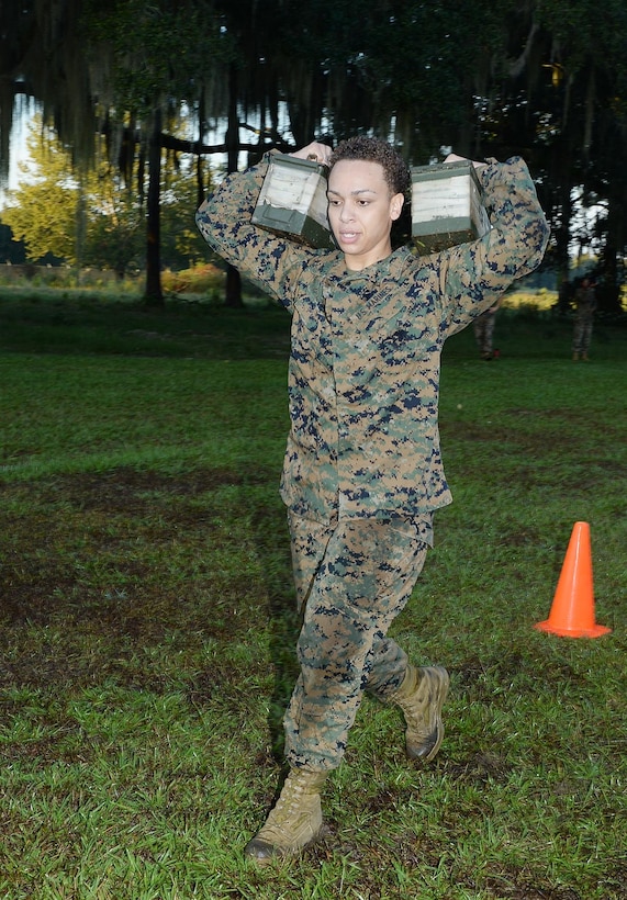 Sgt. Melissa Rodriguez, supply administrative clerk, Marine Forces Reserve, runs with two 30-pound ammunition cans on her shoulders during a recent Combat Fitness Test aboard Marine Corps Logistics Base Albany. 