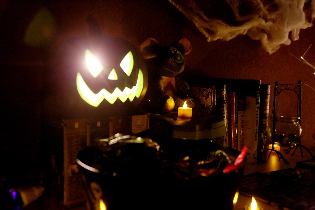 A jack-o-lantern idly sits amongst a Marine’s Halloween-themed decorations during a Haunted Barracks event aboard Marine Corps Air Station Cherry Point, N.C., Oct. 28, 2016. Marine Wing Headquarters Squadron 2 hosted the event to give Marines living in the barracks an opportunity to celebrate Halloween with other MWHS-2 Marines and their families. Children went door-to-door with their parents and received candy from the Marines.