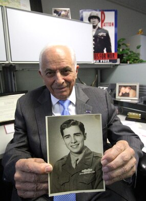 Tony Duno holds a photo of himself as a young soldier during World War II. Duno was awarded a Bronze Star; a Purple Heart and a Combat Infantryman Badge. (U.S. Air Force photo/Debbie Aragon)